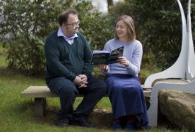Researcher's Tim and Jo sitting on a bench talking