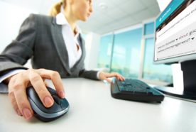 close up of woman using computer in an office