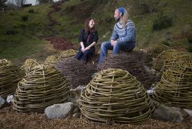 James Eddy and Sarah Bell sit on coppice weave boulders in the River of Life exhibit