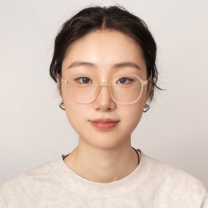 Xinyu smiles for the camera against a flat, off white background.
