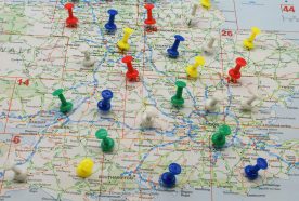 Lots of brightly coloured pins stick in a map of the UK, view centred on the midlands and south
