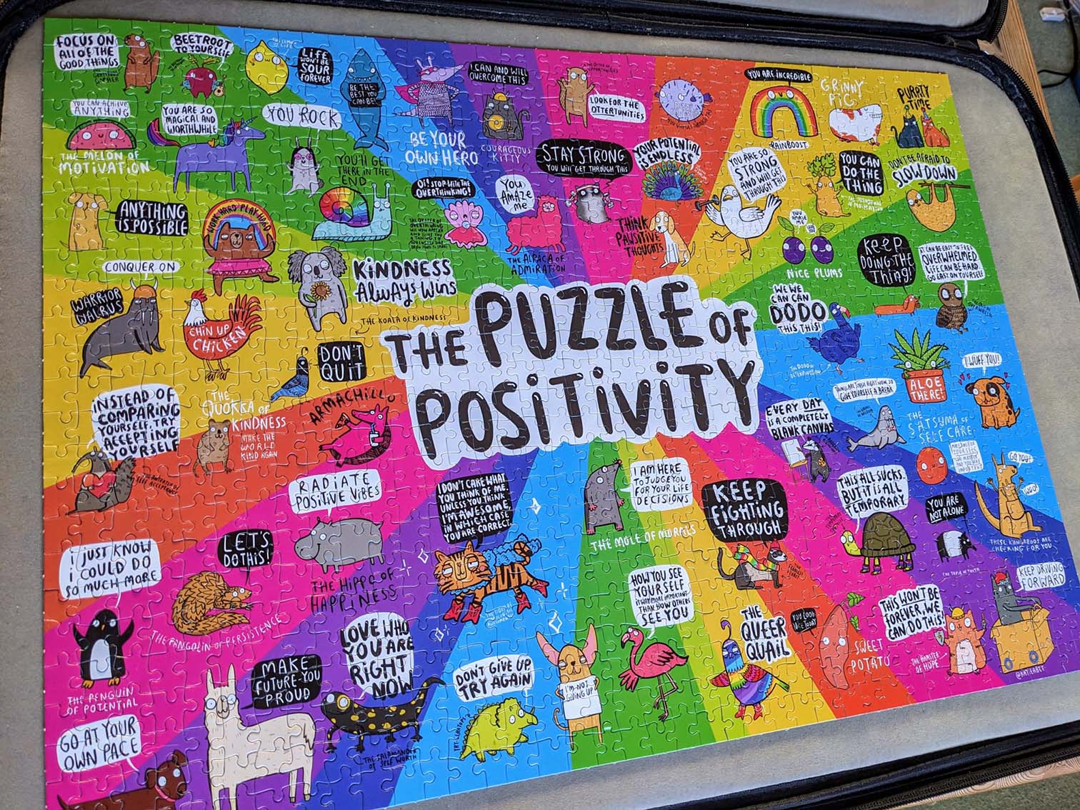 A colourful completed jigsaw puzzle featuring cartoon animals with lots of positive statements.